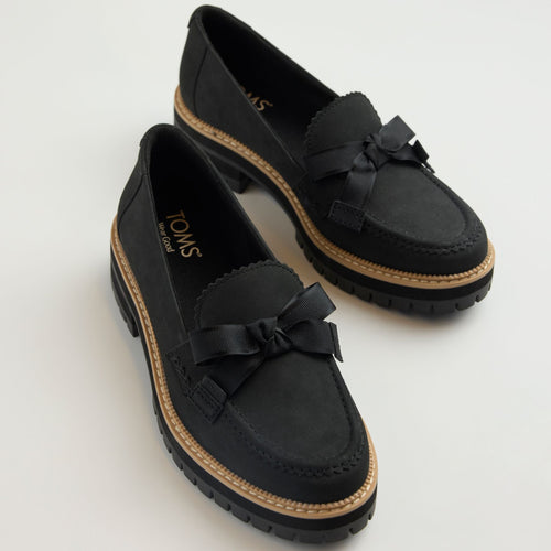 Laydown detail image of the black Cara loafer with bow detail